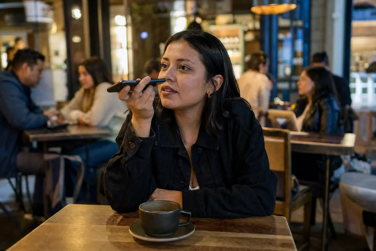 Customer sends a voice note from her phone at a café